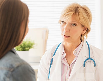 Doctor and patient discussing health needs in office
